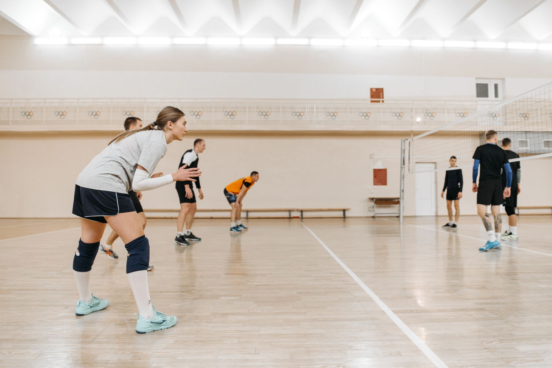People playing a racket sport in a sports hall